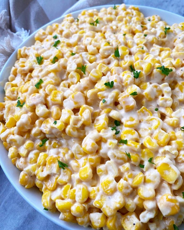 overhead, close up shot of cooked creamed corn in a white bowl