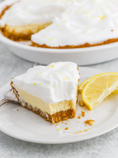 A slice of lemon icebox pie on a white plate that has been eaten