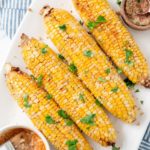 air fried corn cobs topped with parsley on a plate
