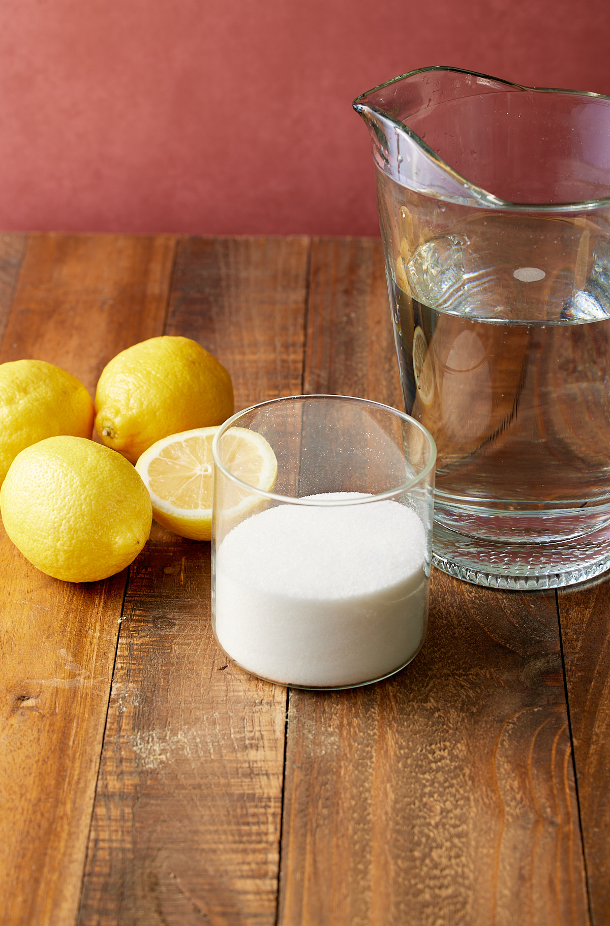 ingredients for lemonade, lemons, granulated sugar, and water