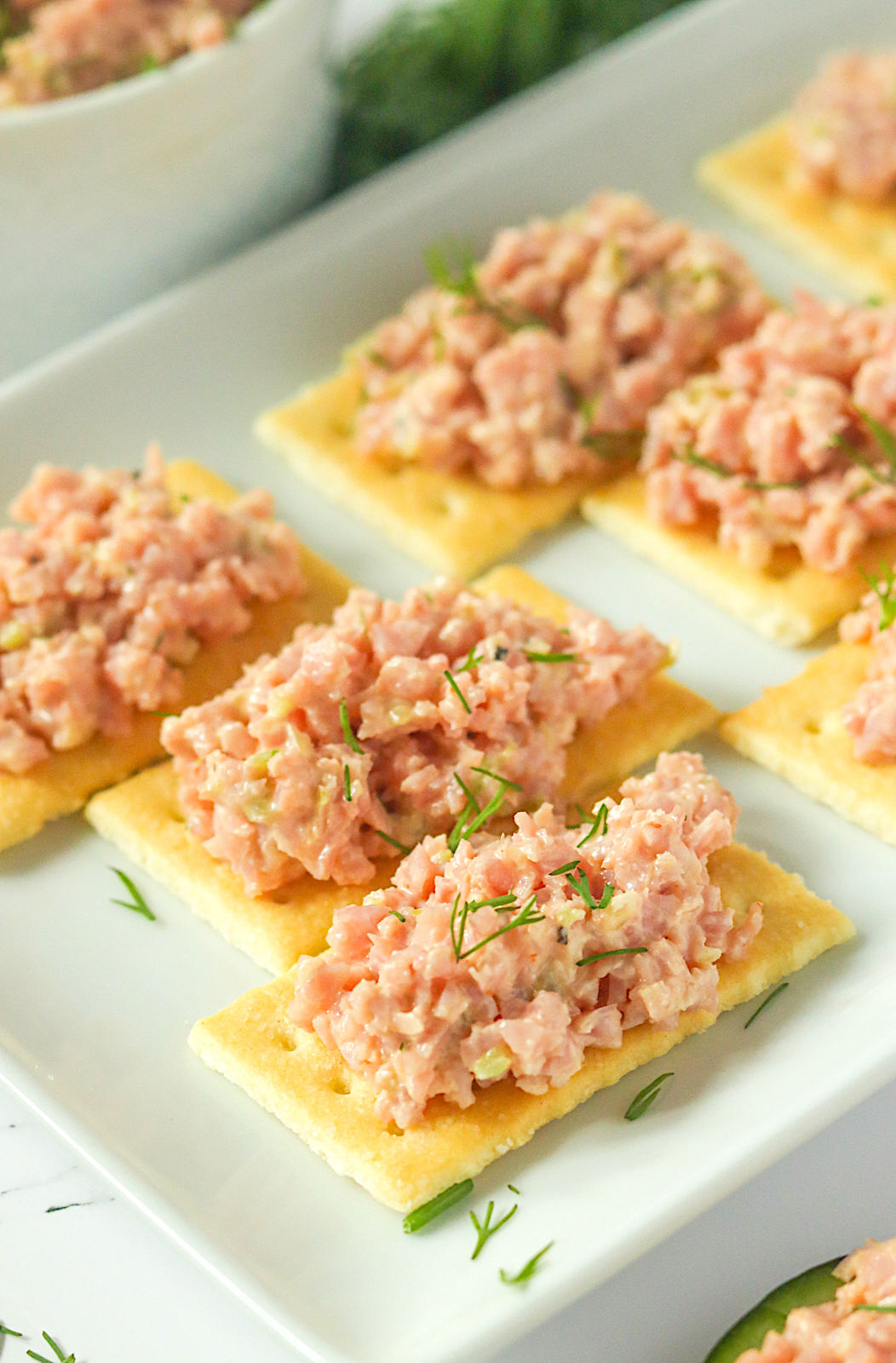Deviled ham ramping up butter crackers for a great snack