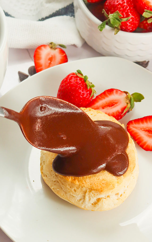 Drizzling chocolate gravy over soft and fluffy biscuits