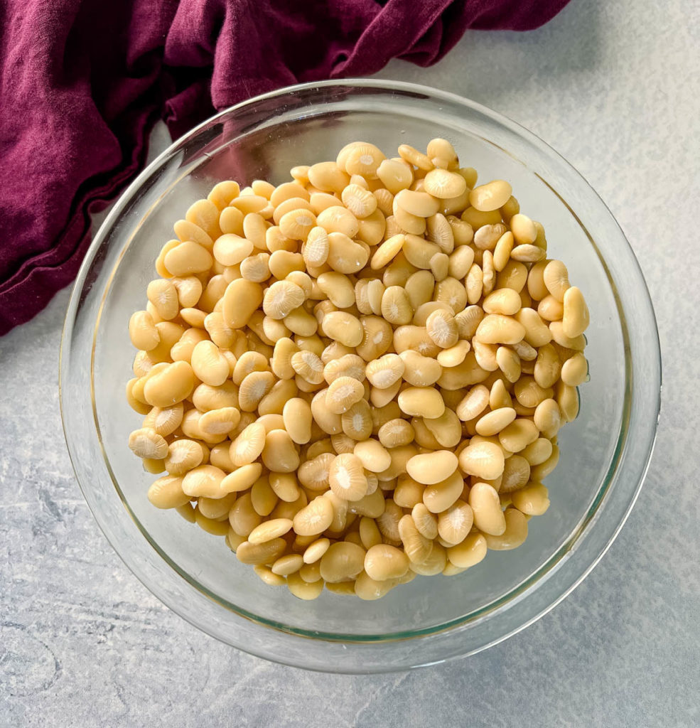 dry lima beans in a glass bowl