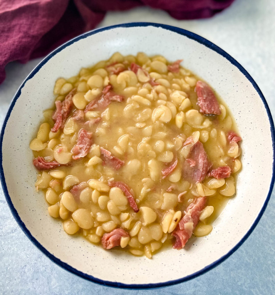 lima beans and smoked turkey in a white bowl