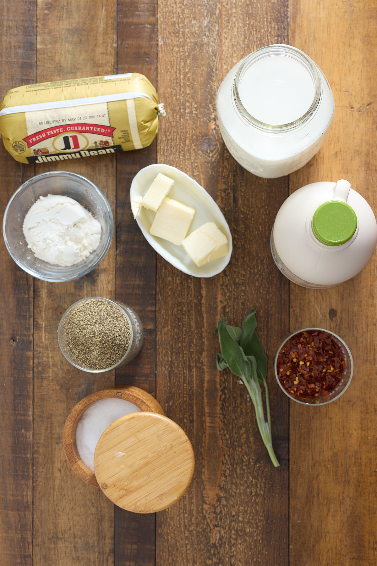 ingredients for sausage gravy on a wooden table