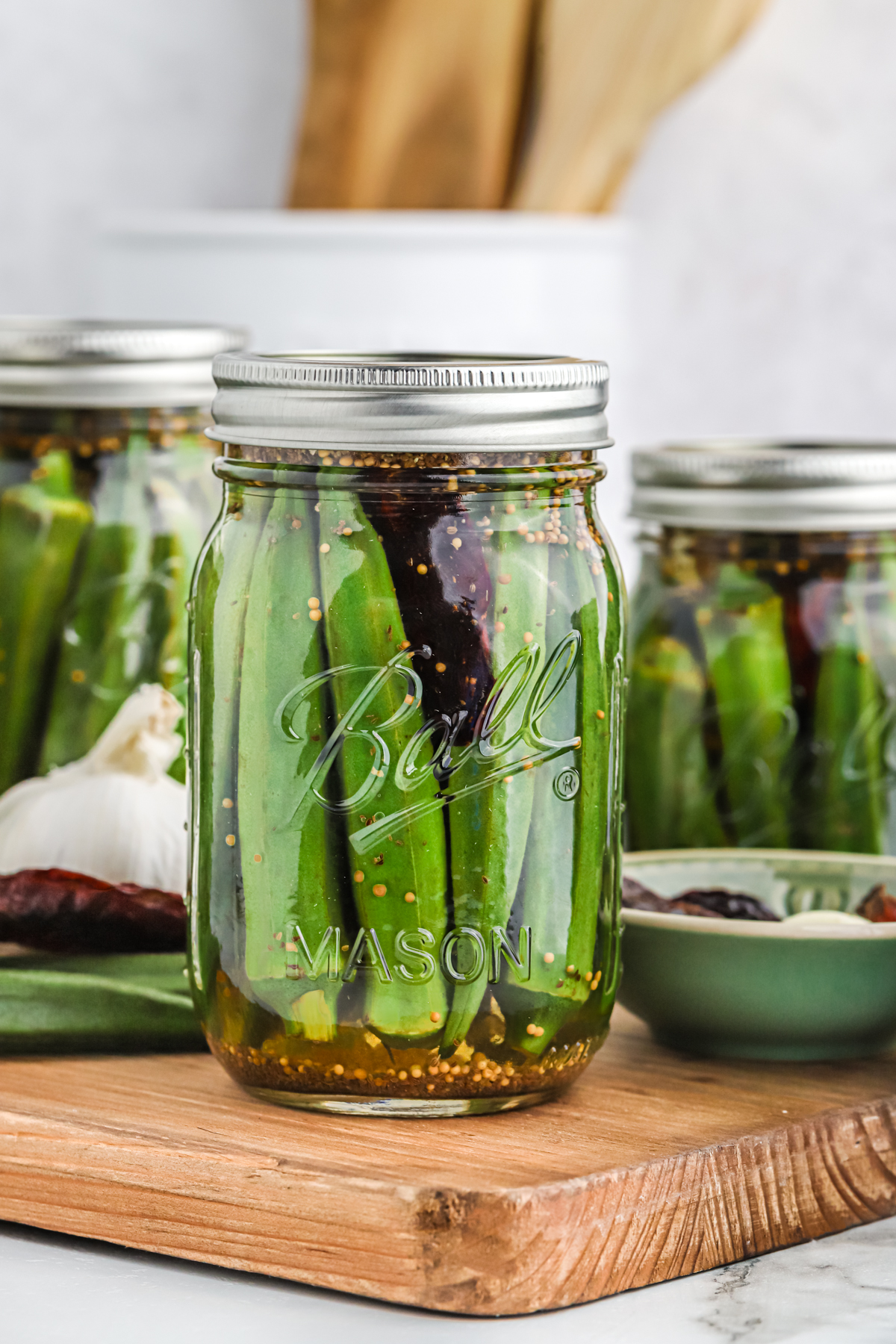 Sealed pint jars of pickled okra.