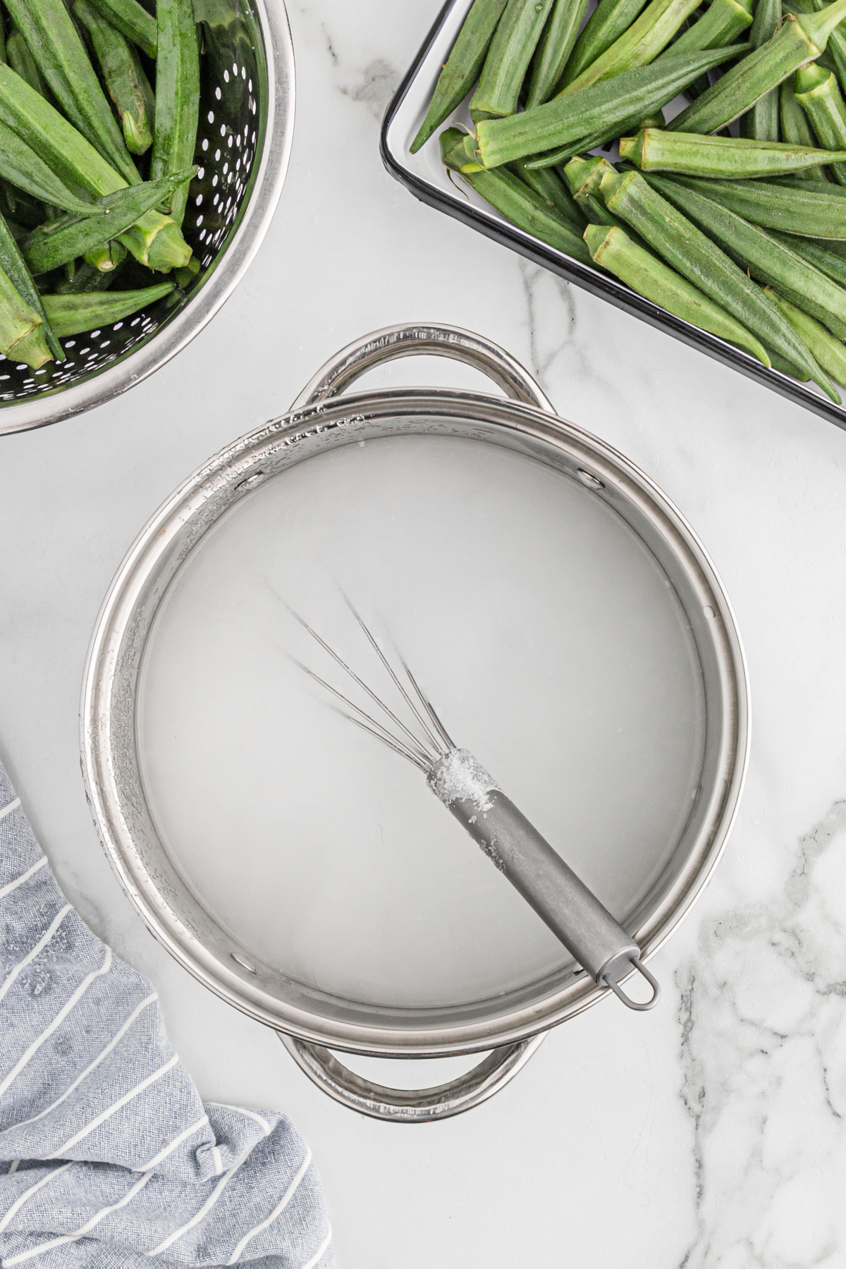 Pickling liquid and a whisk in a large stockpot.