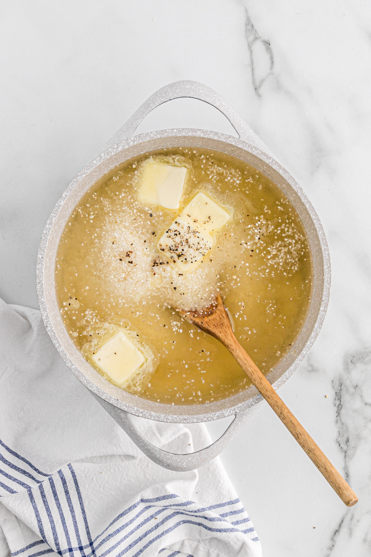 Butter and broth simmering in a large pot.