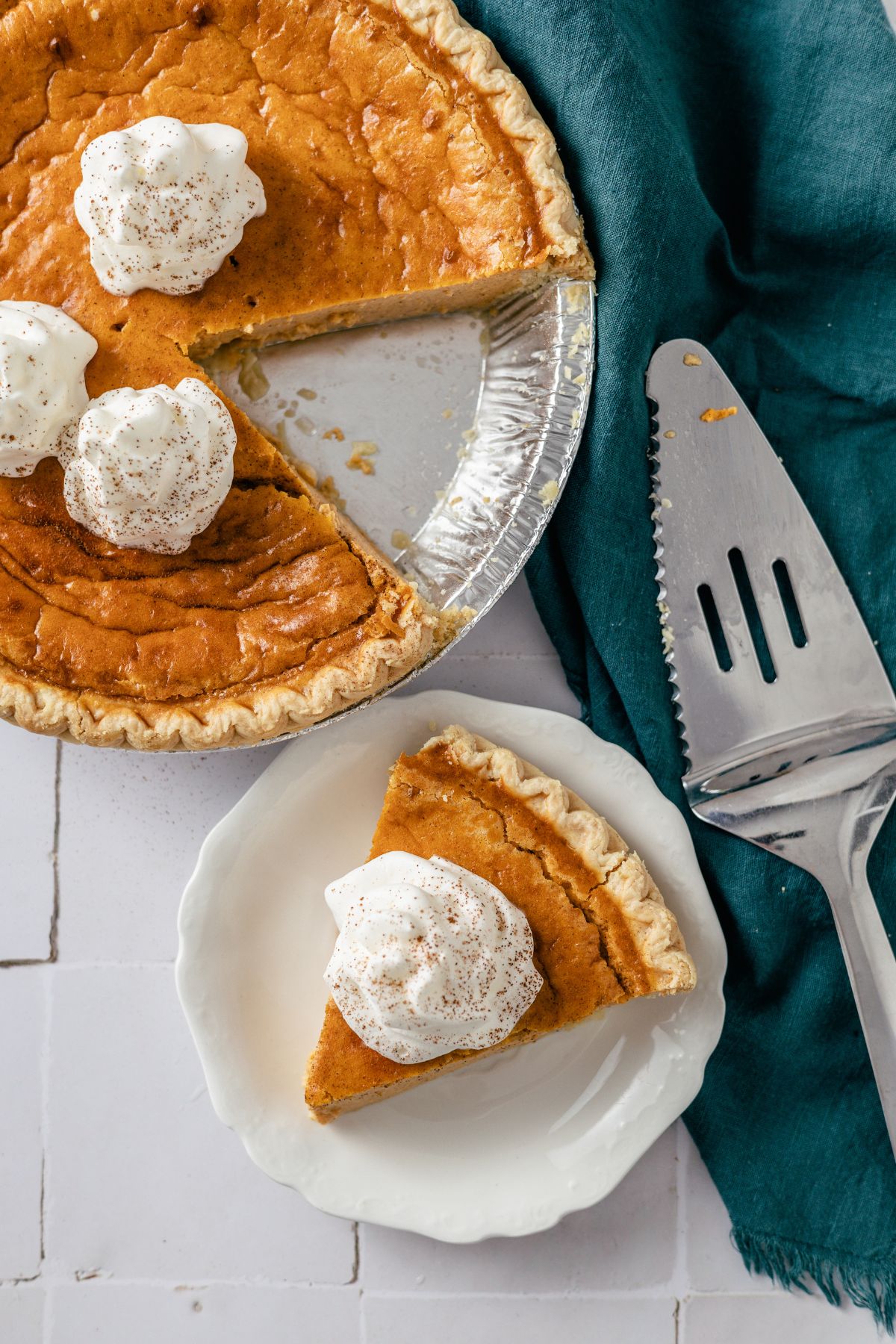 Sweet Potato Pie with Condensed Milk topped with whipped cream on a plate