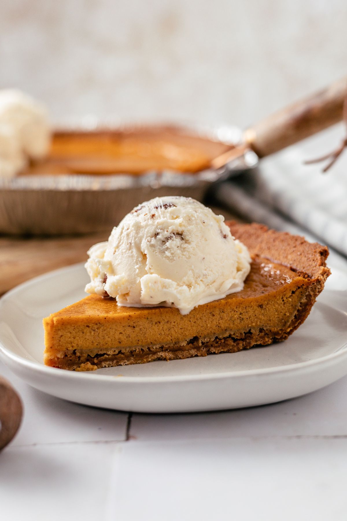 a slice of Sweet Potato Pie with Graham Crust topped with butter pecan ice cream