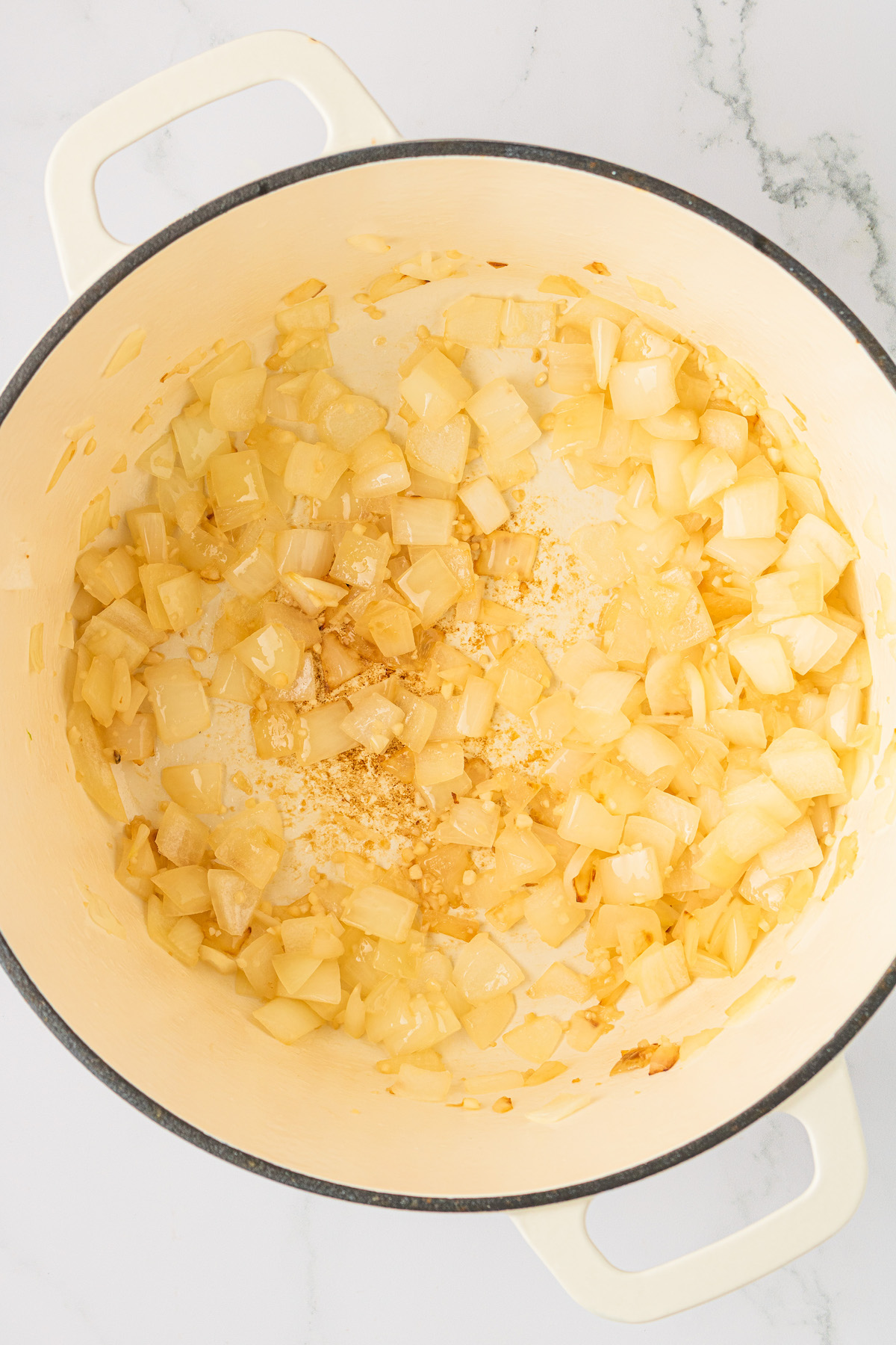 Overhead view of onions in Dutch oven