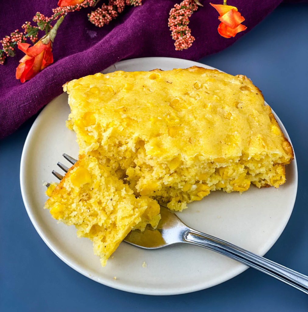 cornbread casserole on a plate with a fork