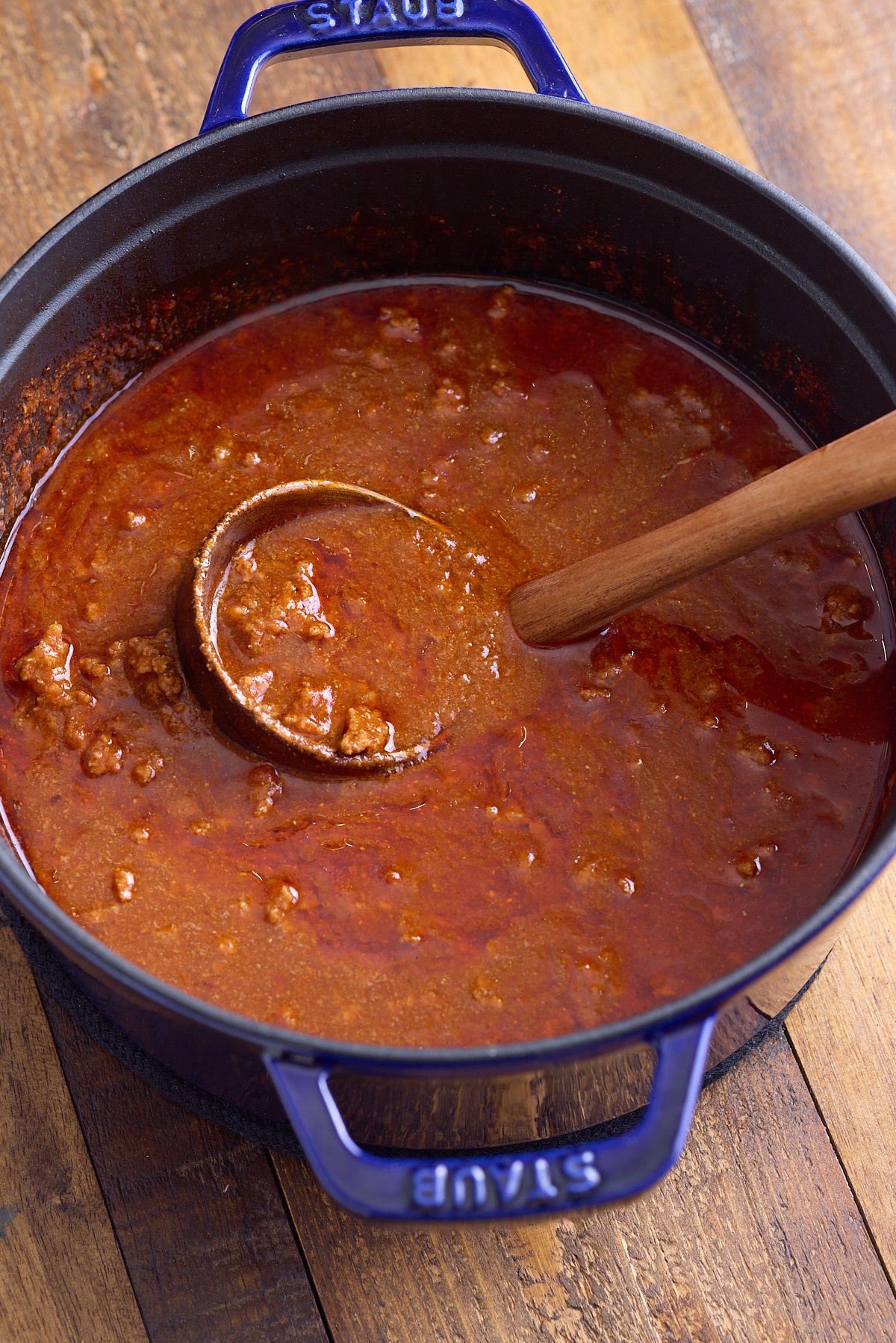 cooked hot dog chili with ladle in pot