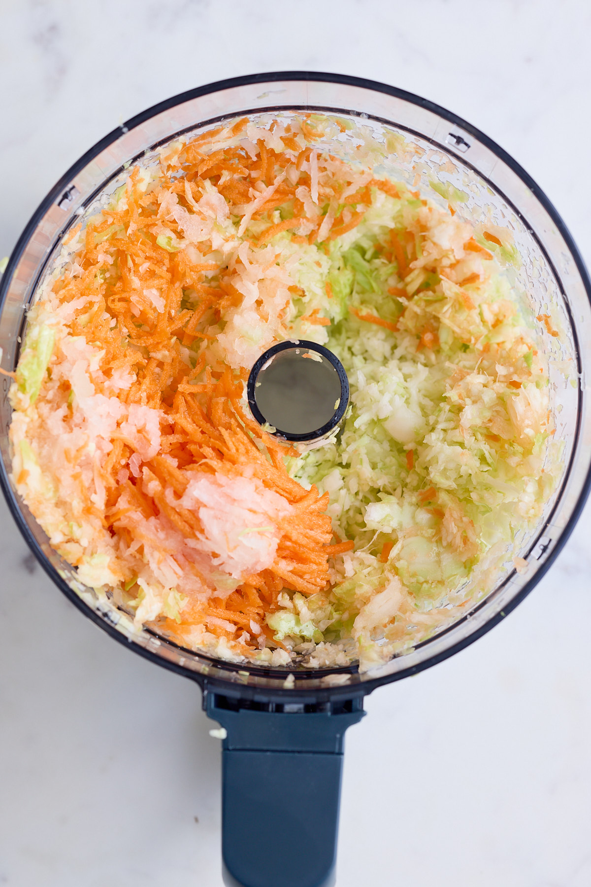 shredded vegetables in food processor bowl