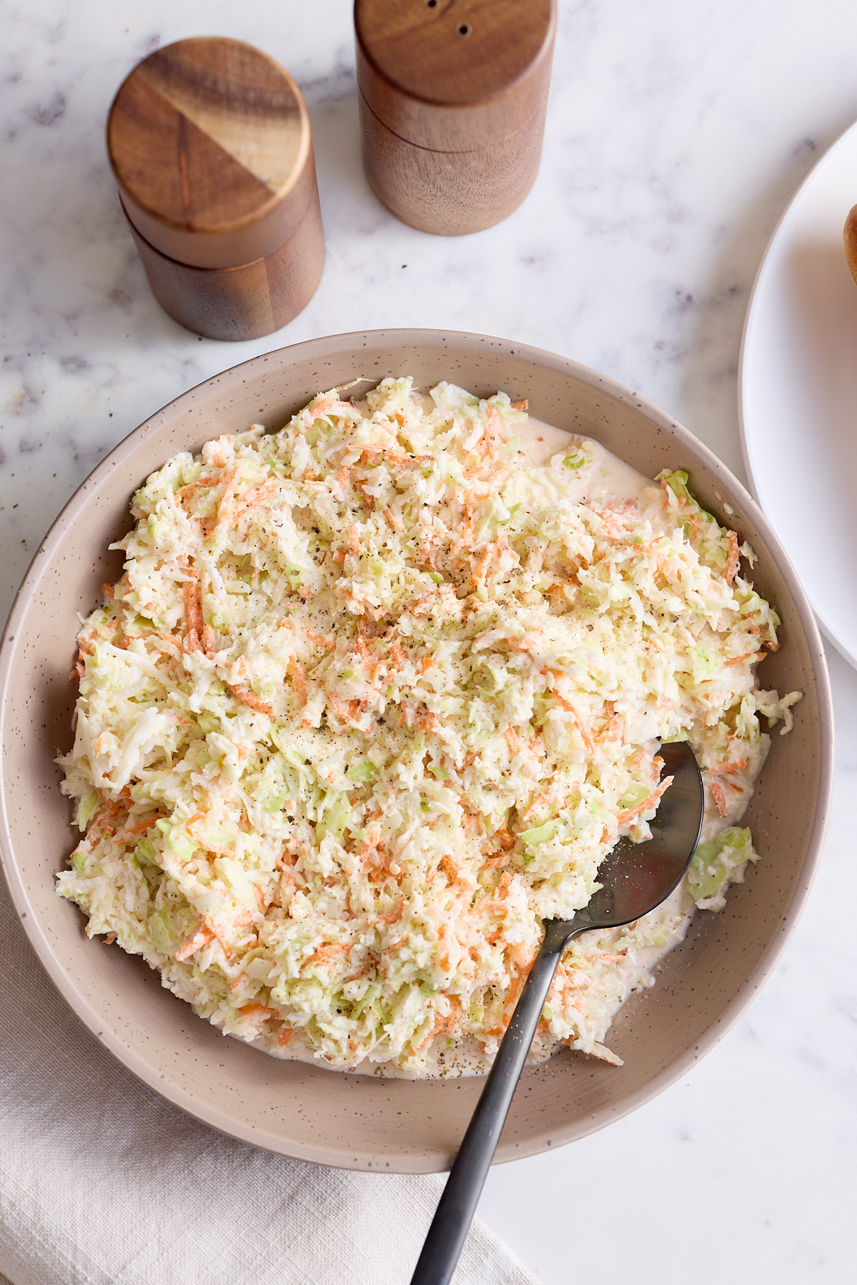 southern coleslaw in bowl with spoon sticking out