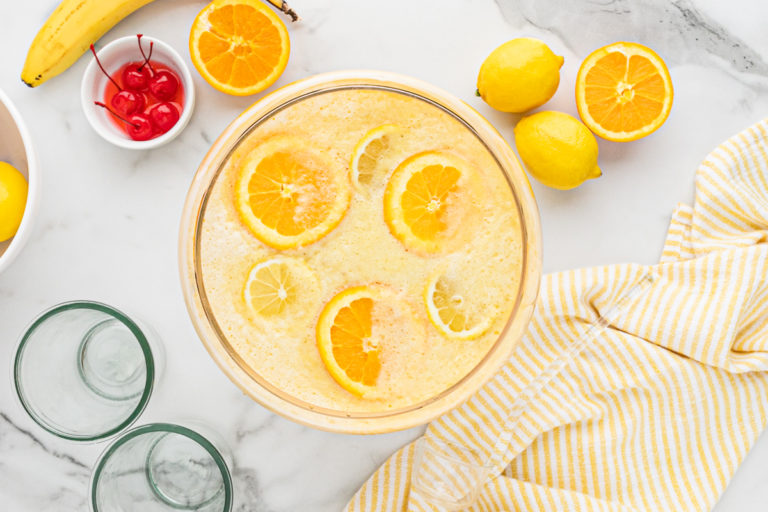 Top view of citrus slices in a bowl of homemade punch.