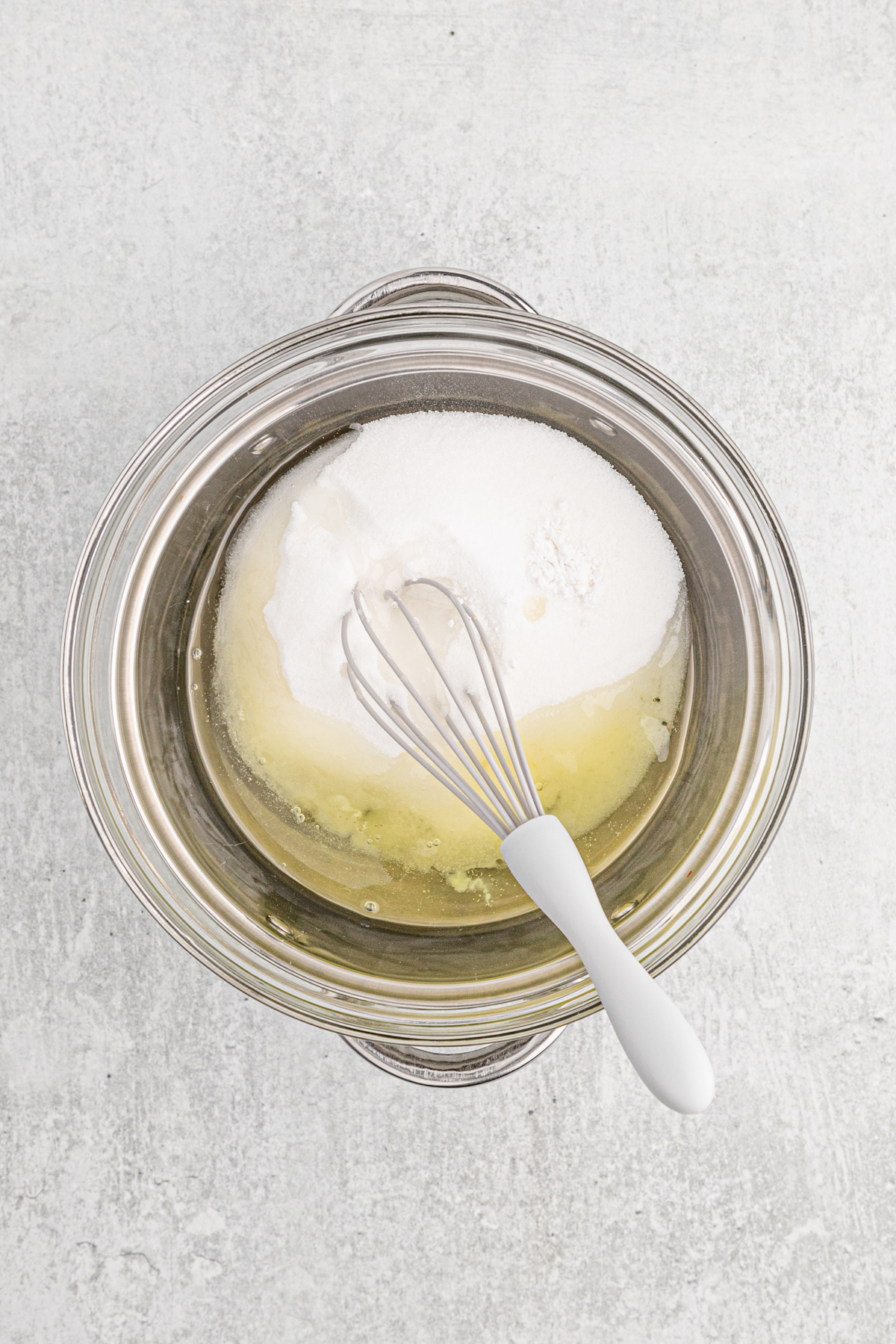 A whisk in a double boiler of sugar and eggs for seven minute frosting.