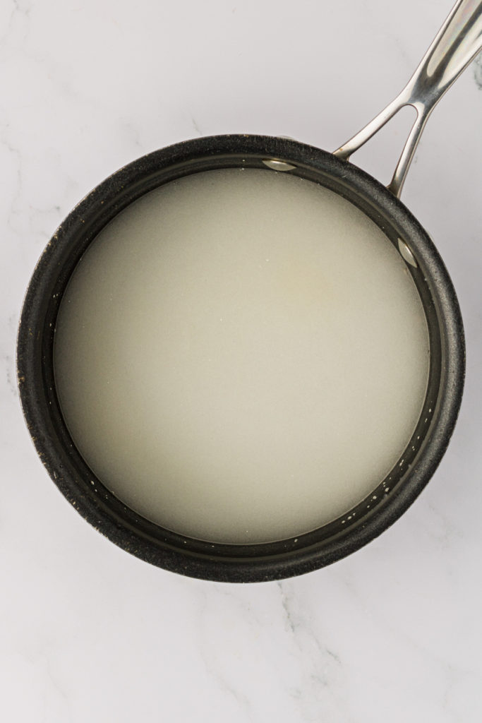 Overhead view of sugar and water mixture in pan
