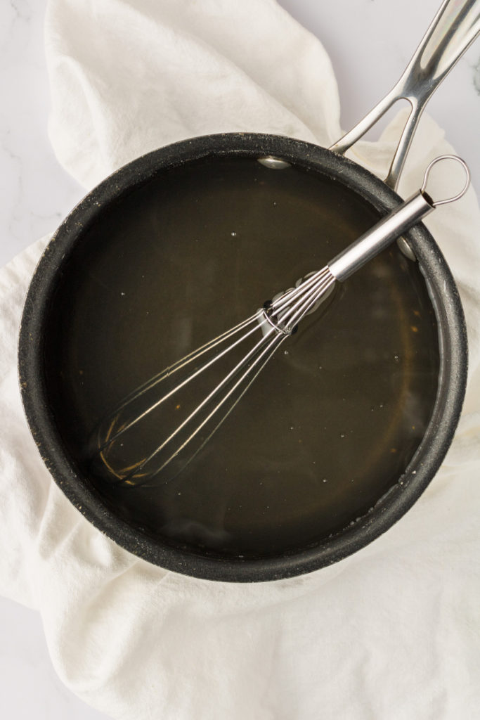 Overhead view of whisk in pan of agar-agar mixture