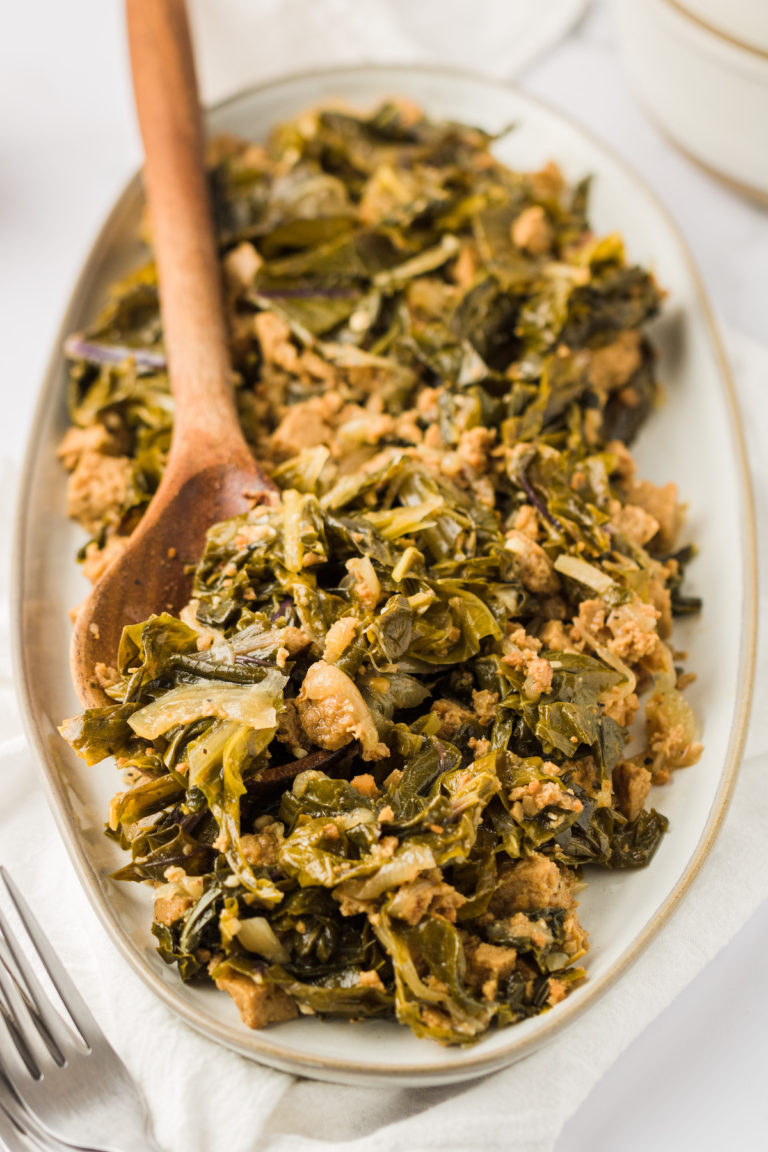 Vegan turnip greens on platter with wooden spoon