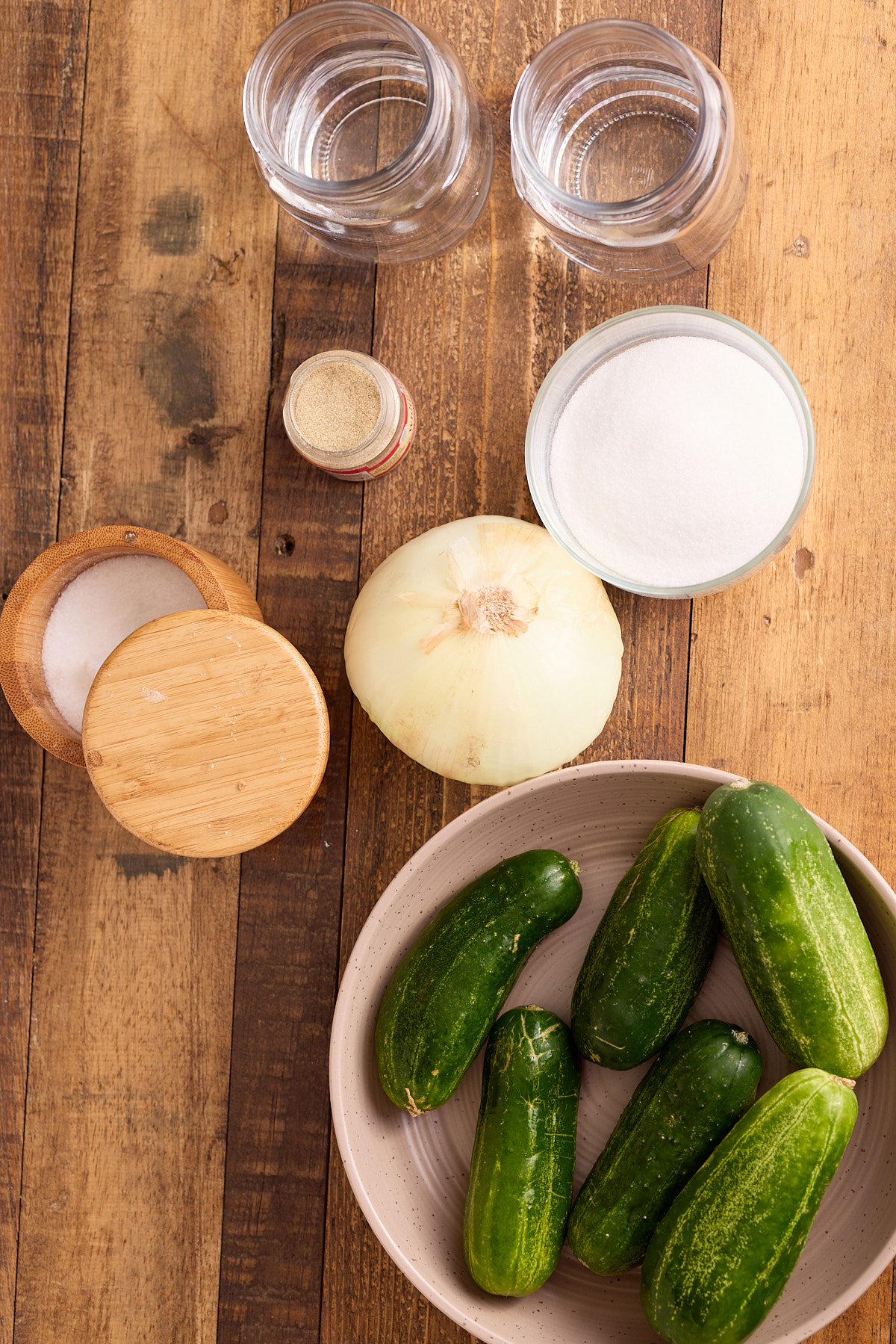 ingredients for refrigerator pickles laid out on backboard