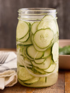 refrigerator pickles in glass jar on wood background