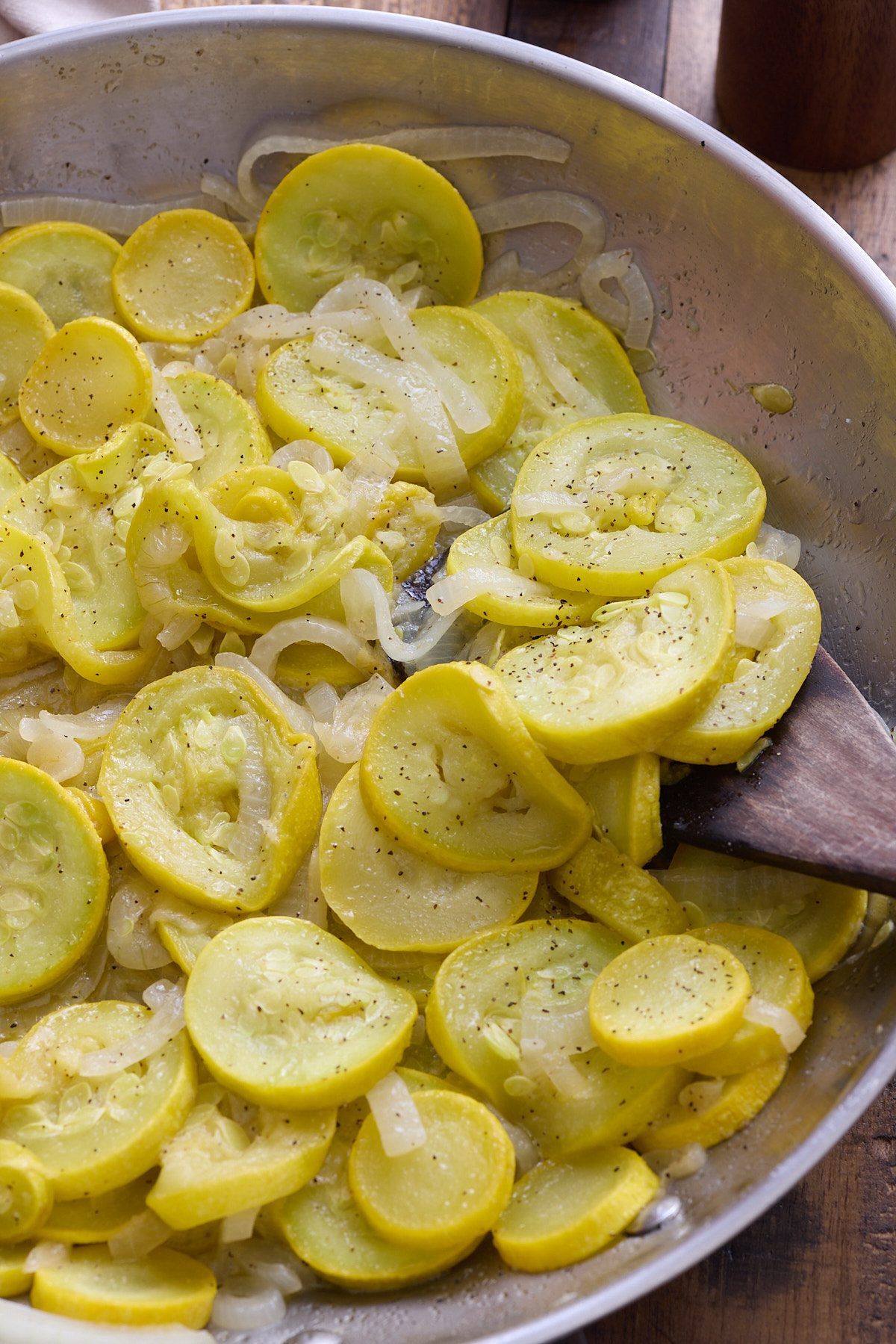 yellow squash in skillet with spatula stirring