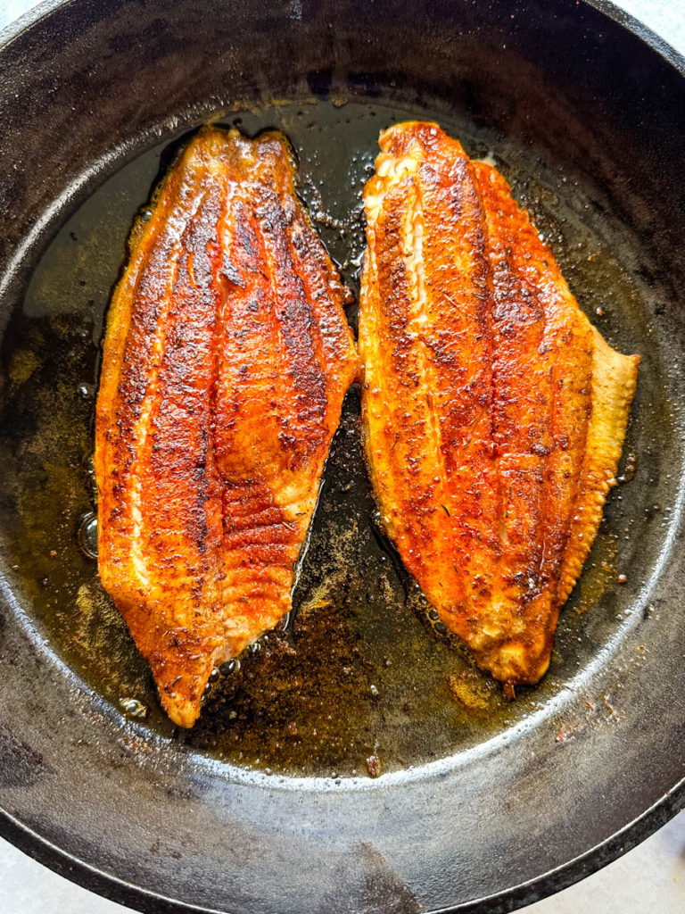 cooked Cajun fish in a cast iron skillet
