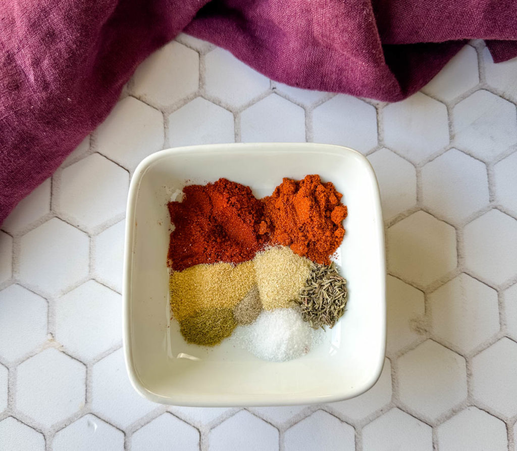 spices for homemade Cajun rub and seasoning in a white bowl