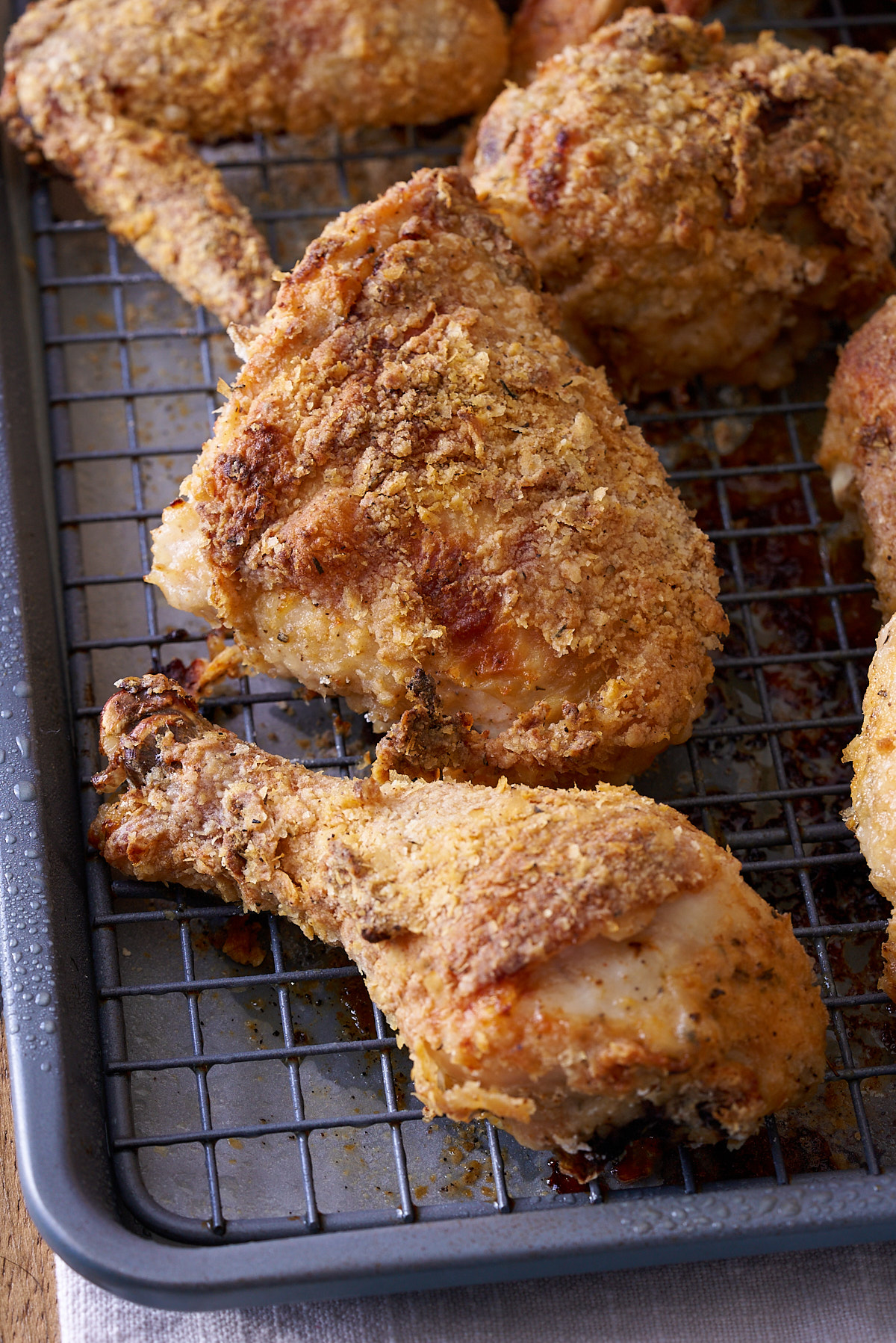 cooked crispy oven fried chicken on rack