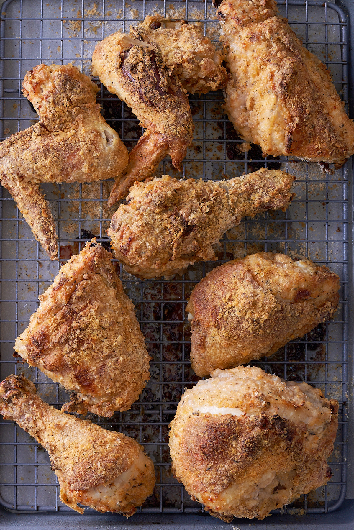 cooked crispy oven fried chicken on baking rack