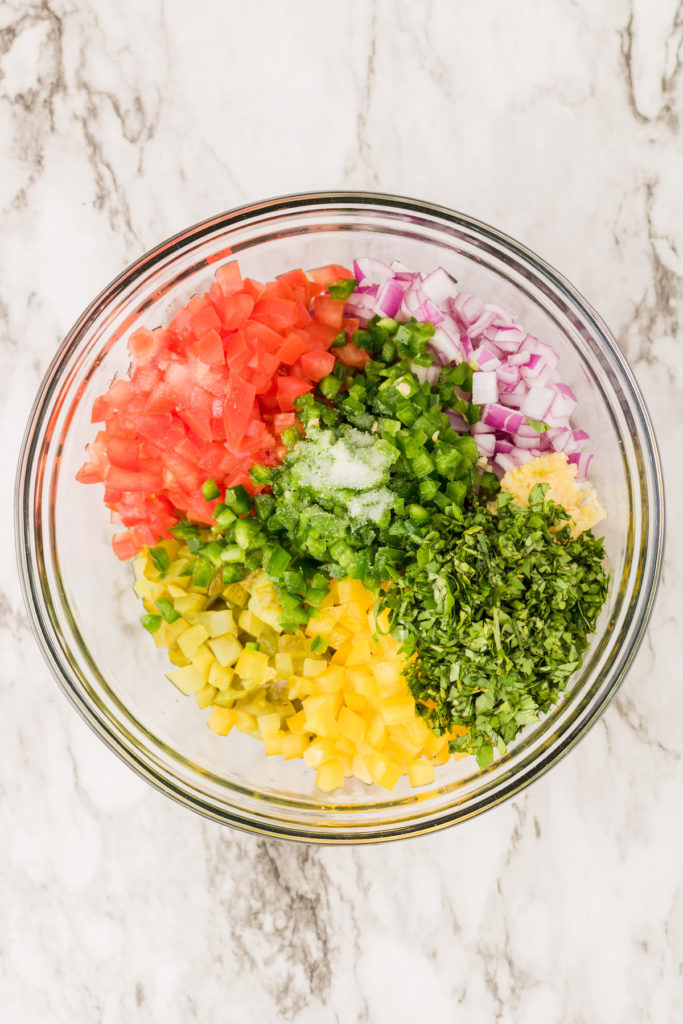 Overhead view of pickle de gallo ingredients in glass bowl