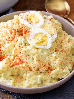 southern potato salad in bowl with eggs on top
