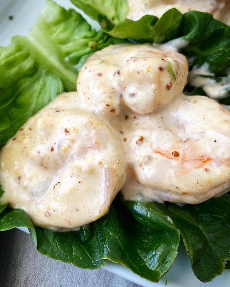 close up shot of shrimp remoulade on green lettuce