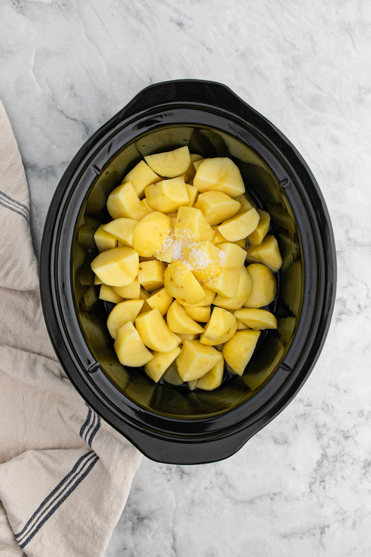 Potatoes diced in a slow cooker