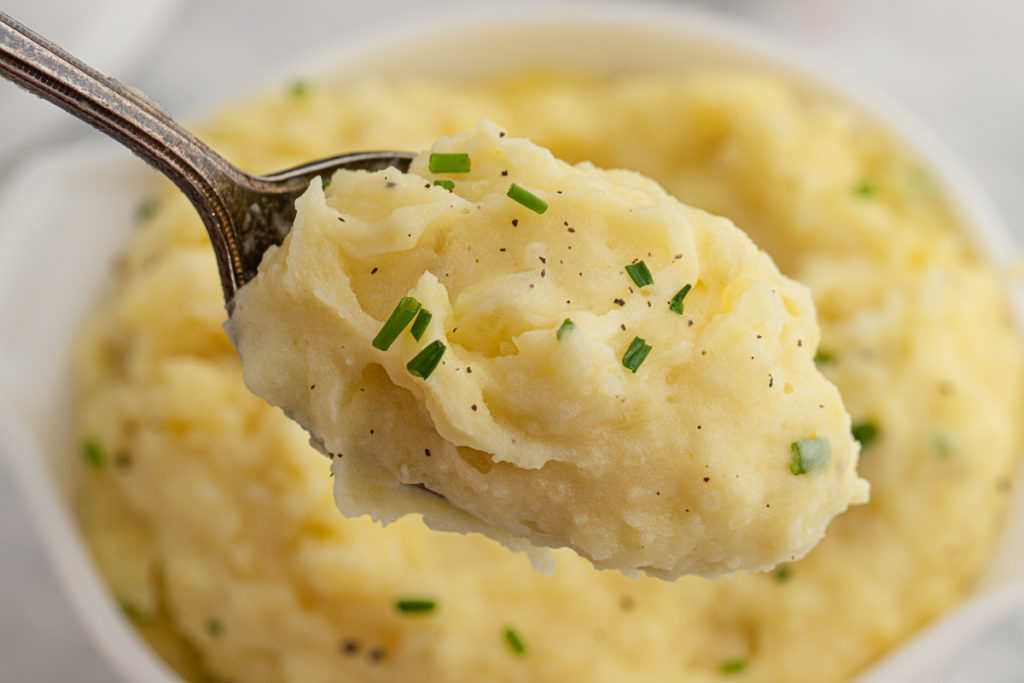 A spoon of mashed potatoes ready to enjoy