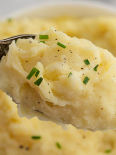 A spoon of mashed potatoes ready to enjoy