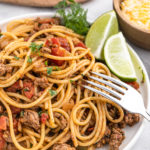 A delicious Taco spaghetti recipe on a white plate being served