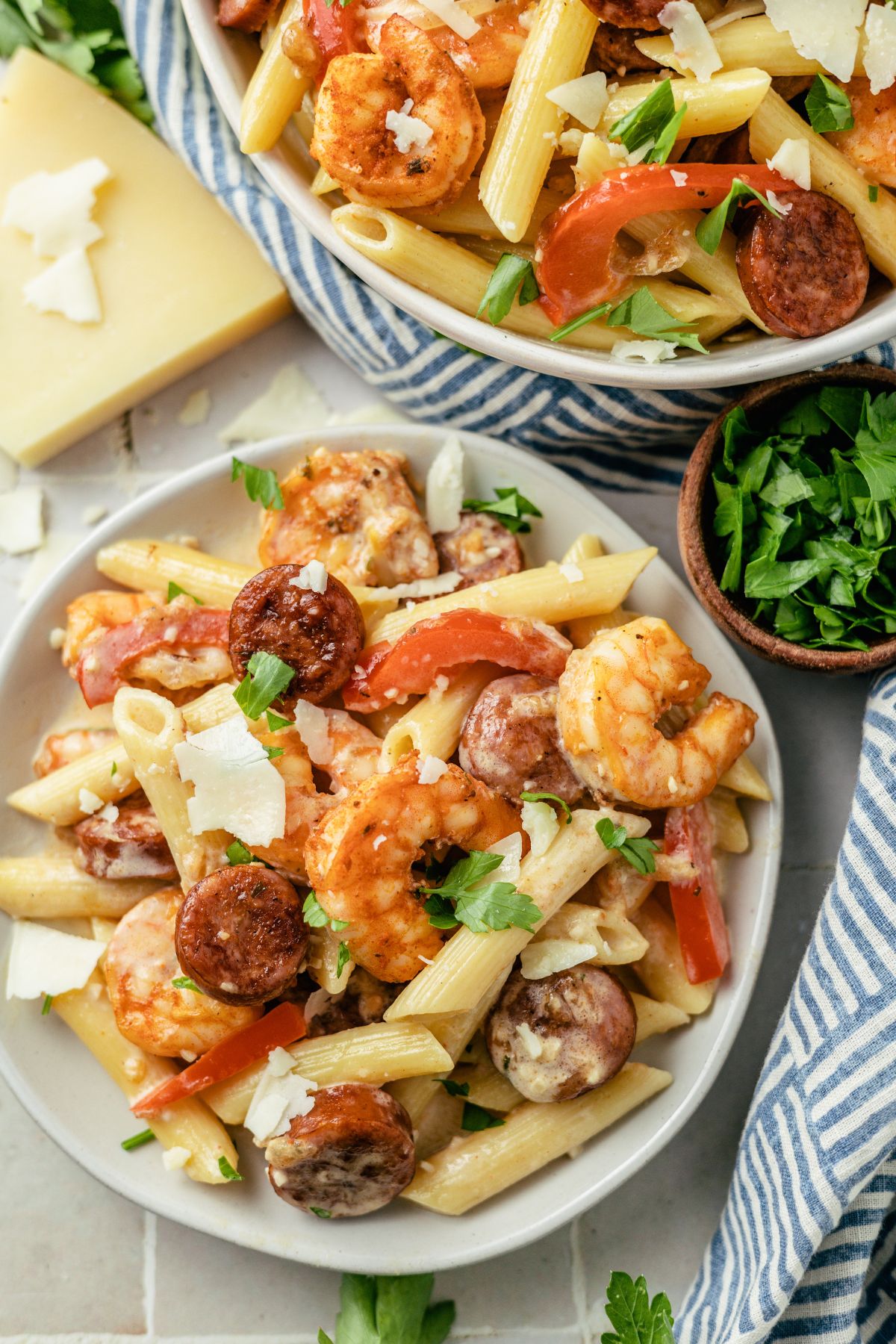 Cajun Shrimp and Sausage Pasta on a large bowl topped with some cheese