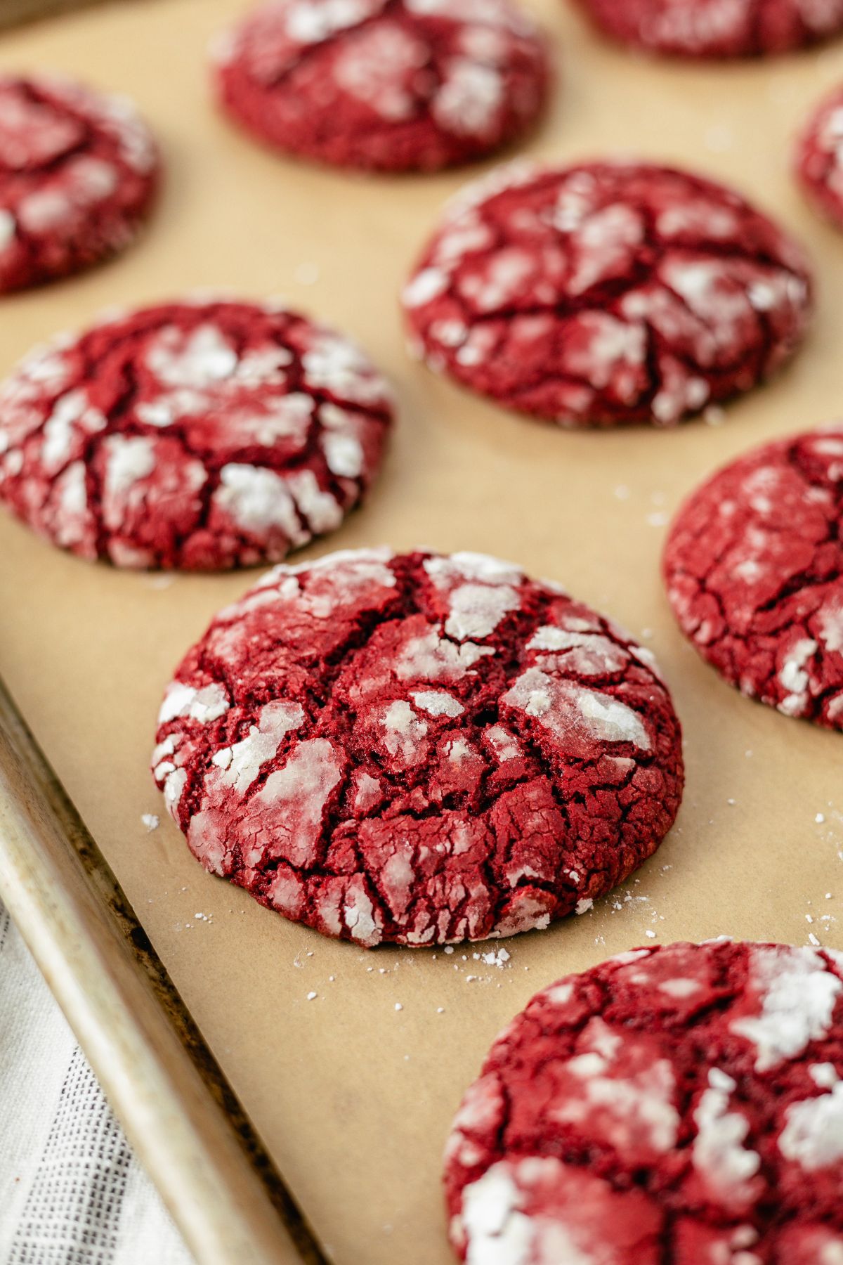 Red Velvet Cake Mix Cookies lined on a brown parchment paper