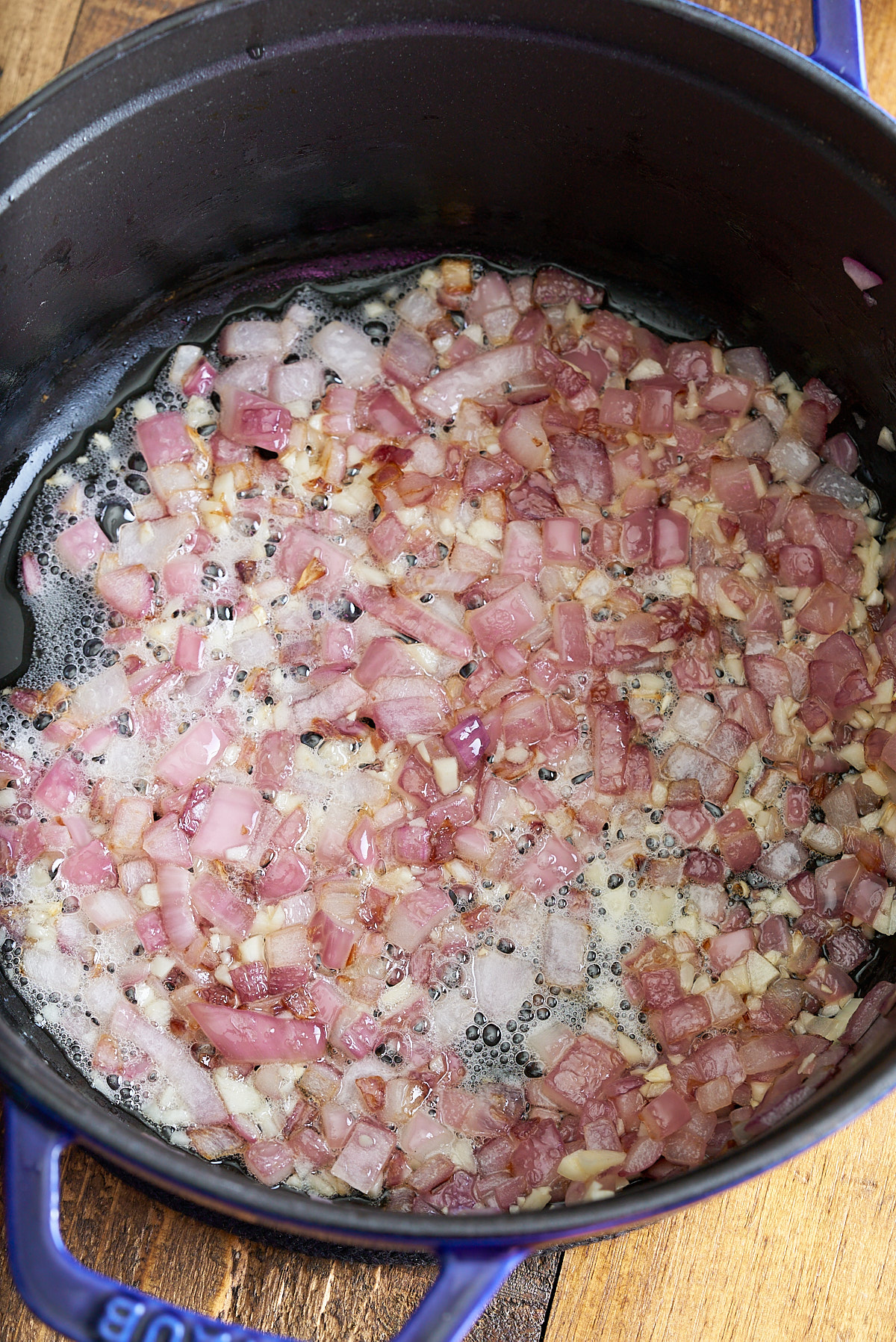 onions and garlic cooking in bacon grease