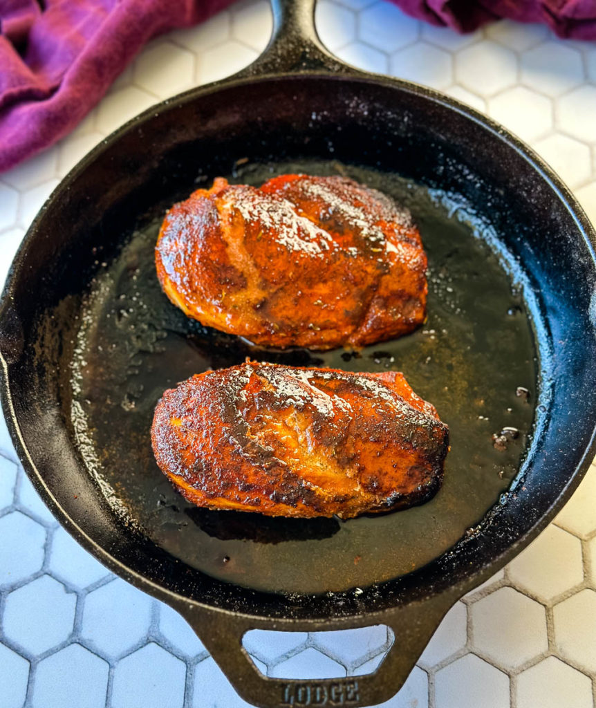 cooked Cajun chicken breast in a cast iron skillet