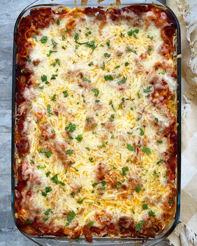 overhead shot of cooked baked spaghetti garnished with parsley