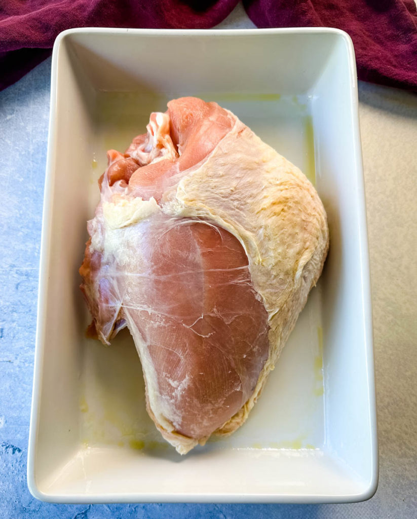 raw bone in turkey breast in a pan