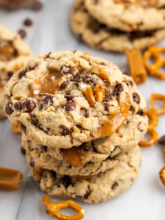 Stack of 4 kitchen sink cookies, with additional cookies in background
