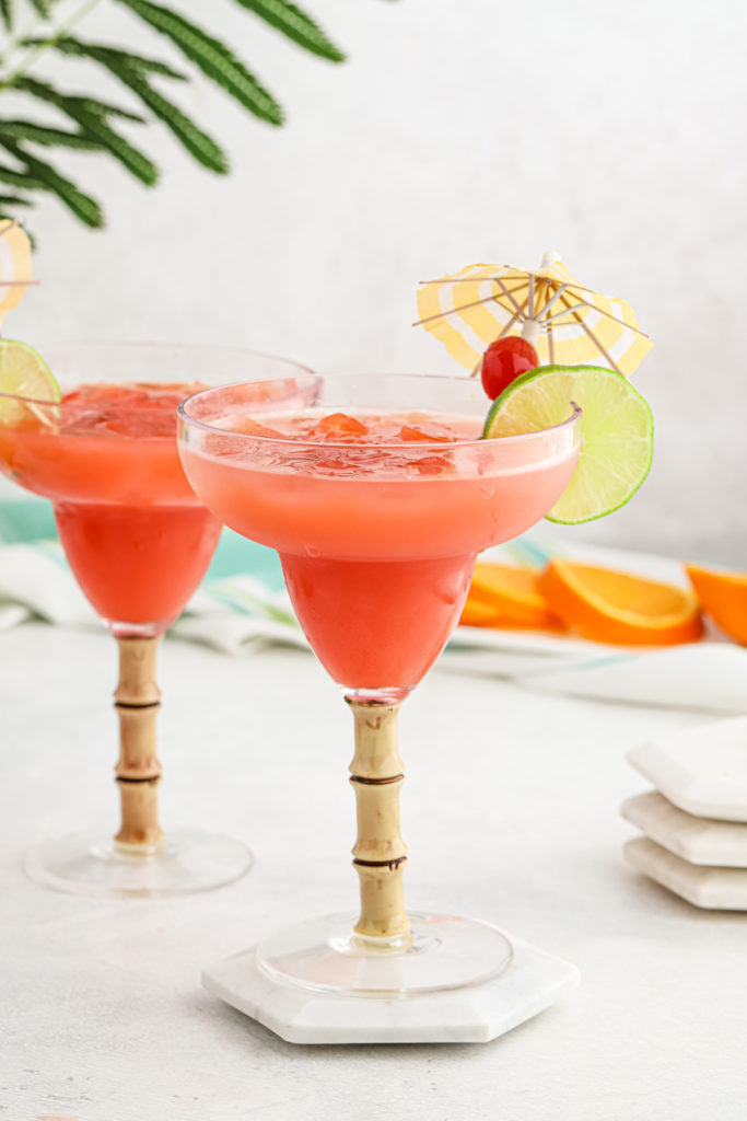 Two glasses of Caribbean Rum Punch with an umbrella ready to serve