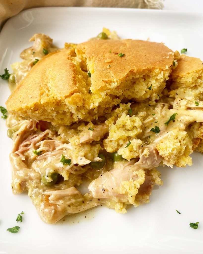 piece of cooked chicken cornbread casserole on a white plate