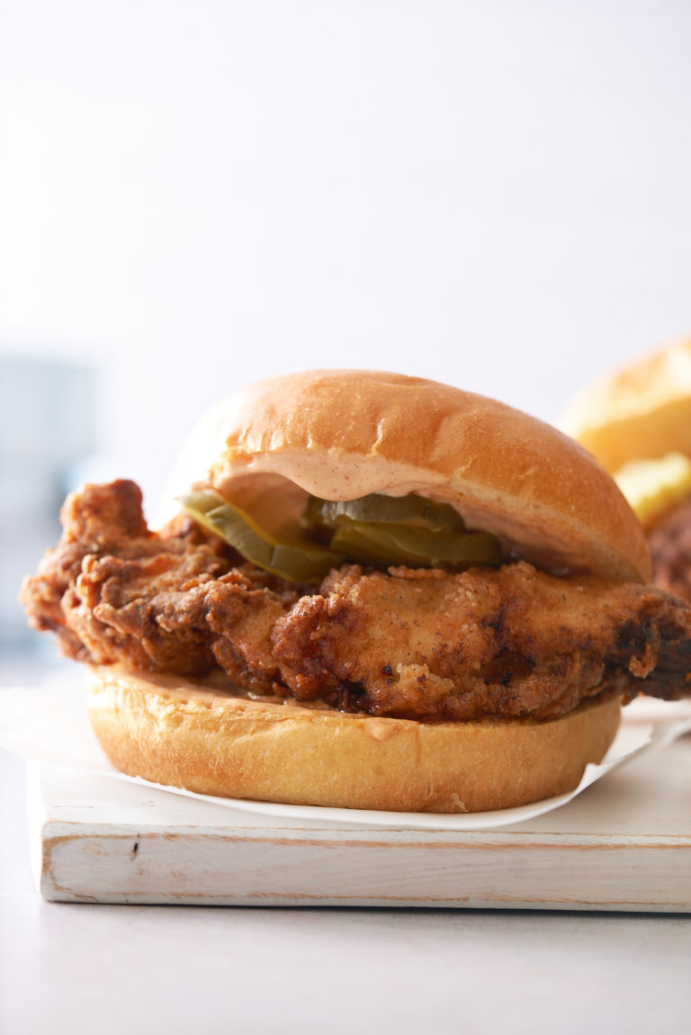 fried chicken sandwich on white cutting board