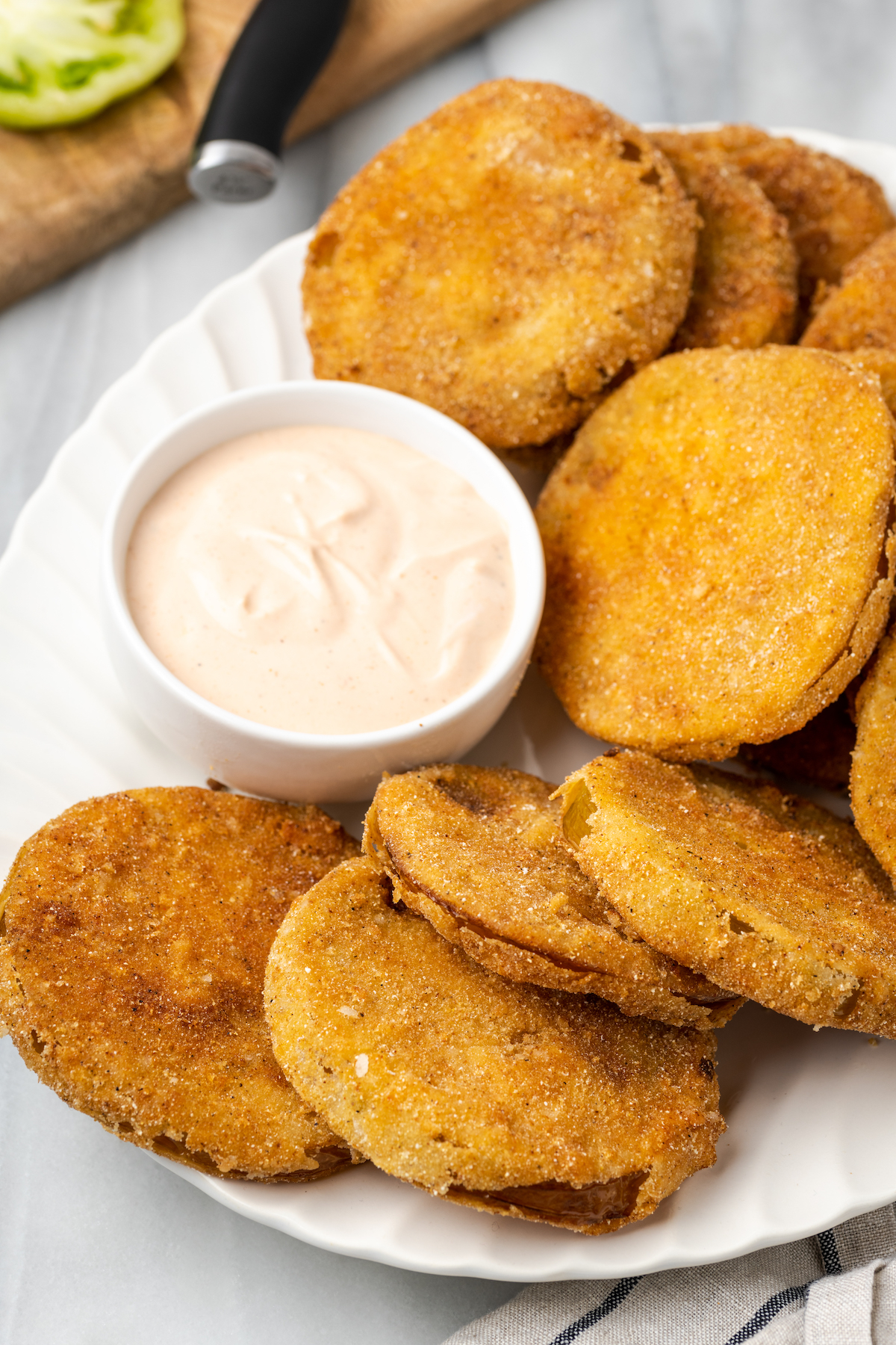 Plate of fried green tomatoes with bowl of comeback sauce