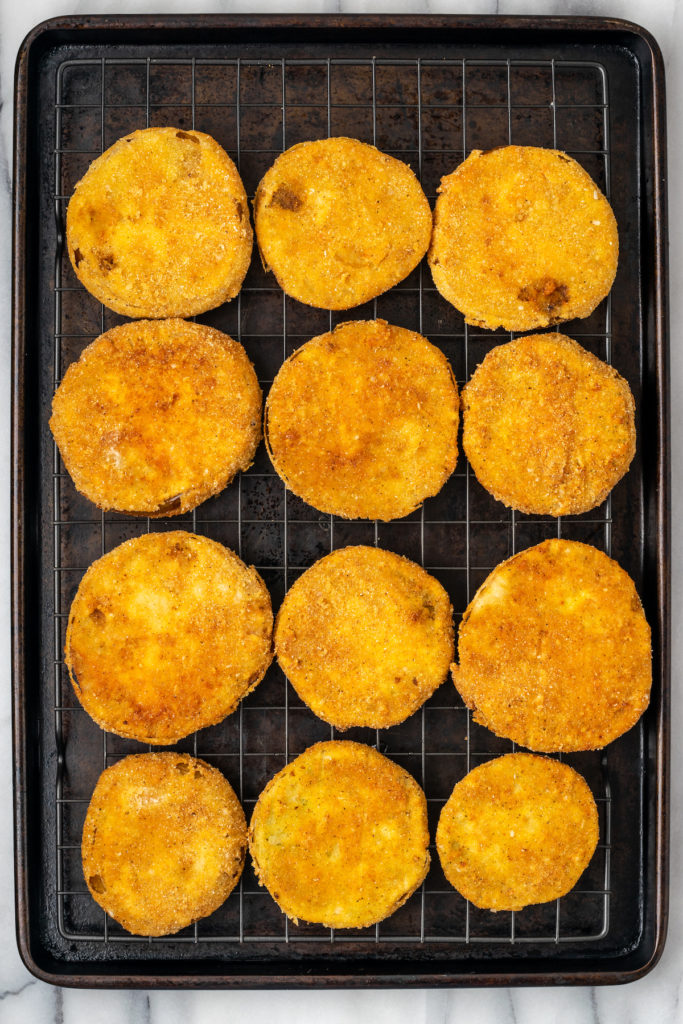 Overhead view of fried green tomatoes on wire rack